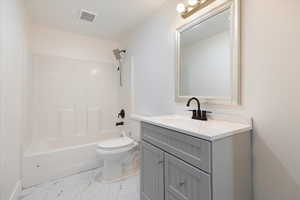 Full bathroom featuring vanity,  shower combination, and light marble finish flooring