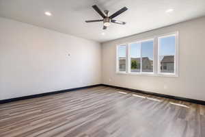 Unfurnished room with wood finished floors, recessed lighting, and a ceiling fan