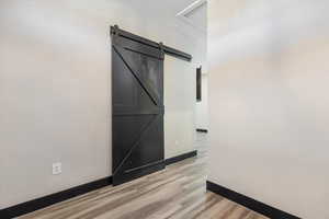 Spare room with light wood-type flooring and a barn door