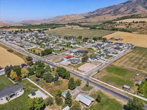 Aerial overview of property's location with nearby suburban area and mountains