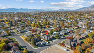 Aerial overview of property's location featuring a mountain backdrop and nearby suburban area