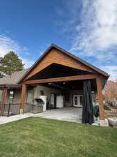Rear view of house featuring the 21x30 heated patio with a sliding shade.