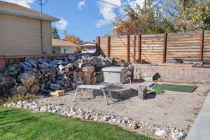 View of yard with an outdoor fire pit and a patio area