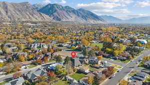 Aerial view of property's location featuring mountains and nearby suburban area