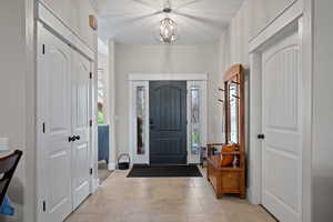 Foyer featuring tile patterned floors and a chandelier