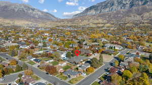 Aerial view of property's location with mountains and nearby suburban area