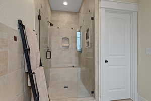 Bathroom featuring a stall shower and recessed lighting