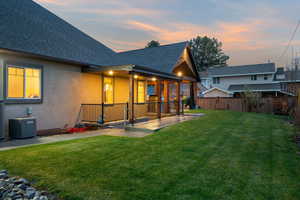 Rear view of property featuring roof with shingles and stucco siding