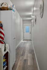 Hallway from outside entrance LVP floors and baseboards