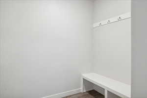 Mudroom featuring wood finished floors and baseboards