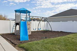 View of playground featuring a fenced backyard