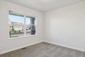 Spare room with baseboards and carpet flooring