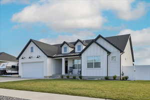 Modern farmhouse style home featuring board and batten siding, a porch, a gate, driveway, and roof with shingles