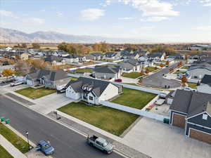 Aerial perspective of suburban area featuring a mountain backdrop