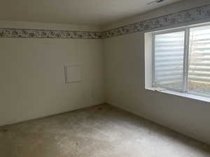 Carpeted empty room featuring baseboards