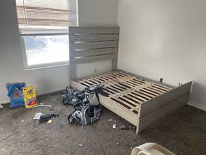 Bedroom featuring baseboards and carpet flooring