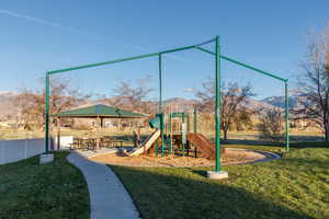 Community jungle gym featuring a yard and a mountain view