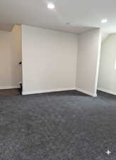 Basement family room with finished storage under the stairs.