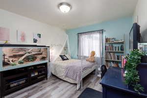 2nd floor guest bedroom with LVP flooring, large closet and large window facing west.