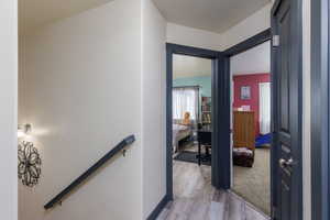 Hallway with an upstairs landing with LVP floors