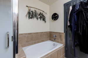 Primary bathroom features a large soaking tub and separate shower.