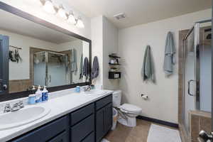 Primary ensuite bathroom with dual sinks, separate soaking tub and shower.