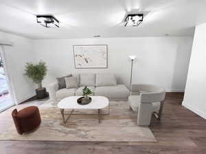 VIRTUALLY STAGED-Living room featuring ample natural lighting, fresh wood style flooring and newly painted timeless two-toned paint with large, modern baseboards