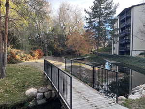 Picturesque views of mountains, slow moving stream, foot path bridges, and wood view