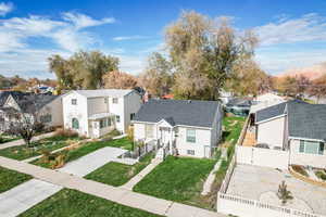 View of front facade with a residential view, a fenced backyard, a gate, and a shingled roof