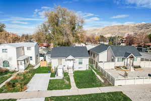 View of front facade featuring a residential view, a mountain view, roof with shingles, and entry steps