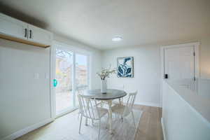 Dining room with light wood-style floors and baseboards
