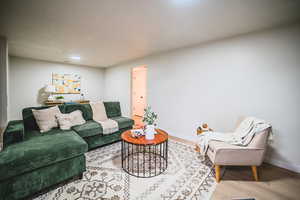 Living area with wood finished floors and baseboards