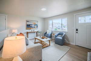 Living room with light wood-style flooring and baseboards