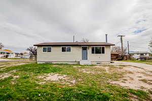 View of front of house featuring a front yard and entry steps