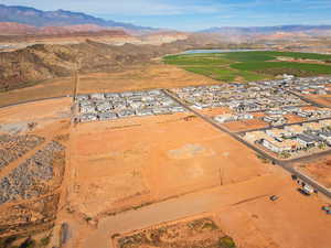 Aerial view of property's location featuring nearby suburban area and a water and mountain view