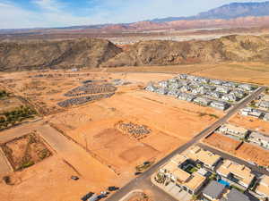 Aerial overview of property's location featuring mountains and nearby suburban area