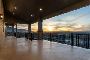 Main level deck with view of valley and surrounding mountains, outdoor lounge area at dusk