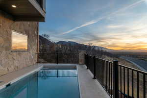 View of swimming pool with spa, featuring patio, valley and mountain views