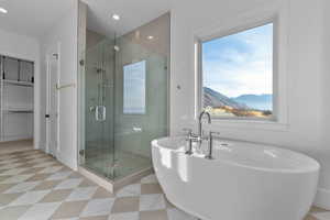 Master Suite bath featuring a freestanding bath, tile stall shower, light tile floor, valley and mountain view, and recessed lighting