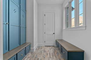 Mudroom off main level garage, built in lockers with benches, storage closet