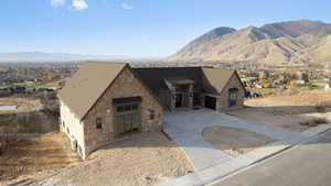 View of front of property featuring stone siding and mountain view