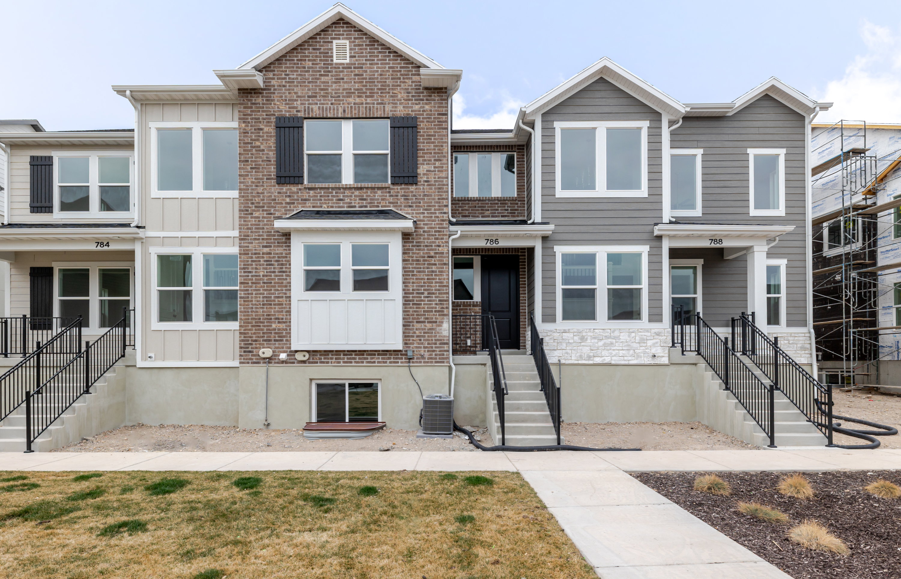 View of front of house featuring board and batten siding and a front lawn