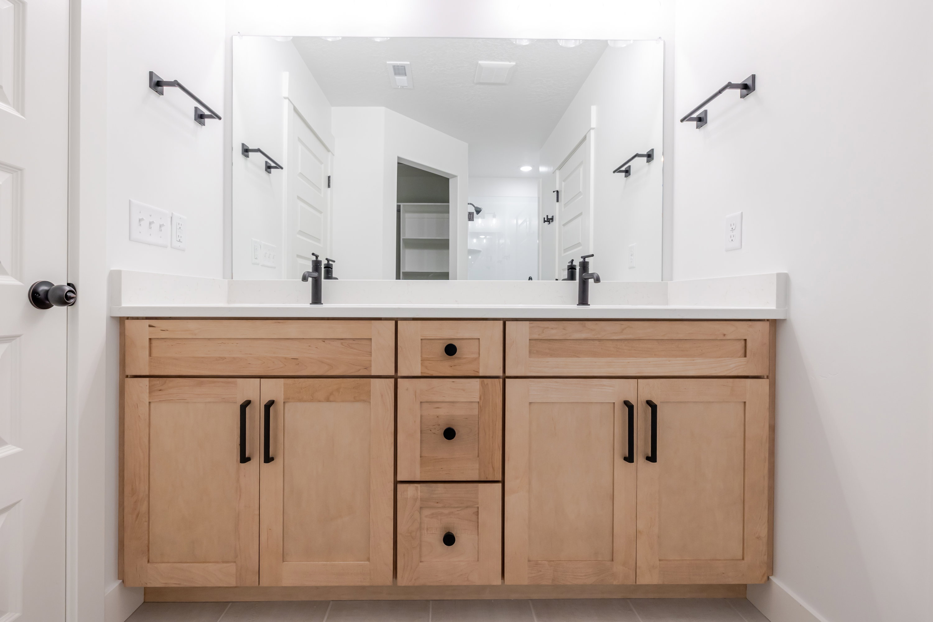 Full bathroom with double vanity and light tile patterned floors