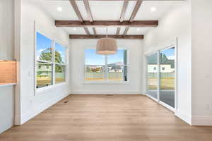 Unfurnished dining area with beam ceiling, light wood-style flooring, recessed lighting, and coffered ceiling
