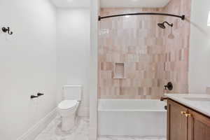 Full bath featuring vanity, shower / bathtub combination, and light marble finish flooring