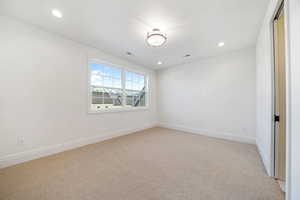 Unfurnished room featuring light carpet and recessed lighting