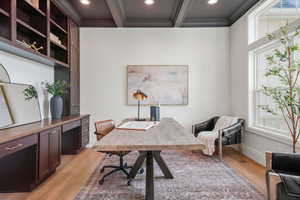 Home office featuring light wood-type flooring, coffered ceiling, ornamental molding, and recessed lighting