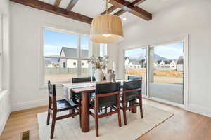 Dining area featuring light wood-style flooring, plenty of natural light, and coffered ceiling
