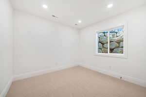 Carpeted spare room featuring baseboards and recessed lighting