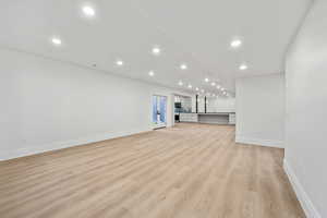 Unfurnished living room featuring light wood-type flooring and recessed lighting